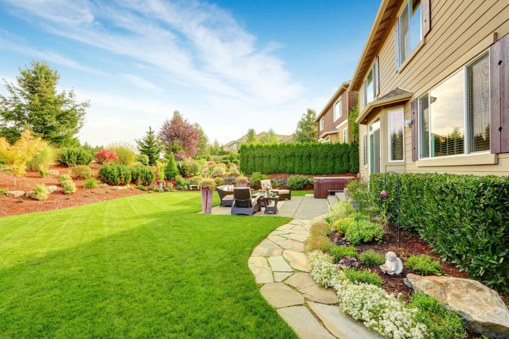 A picturesque backyard featuring a lush lawn and well-maintained landscaping.